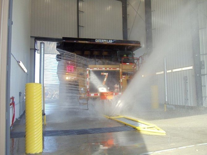 Truck wash with large industrial truck in tunnel