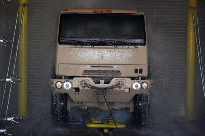 Military vehicle in fleet wash tunnel