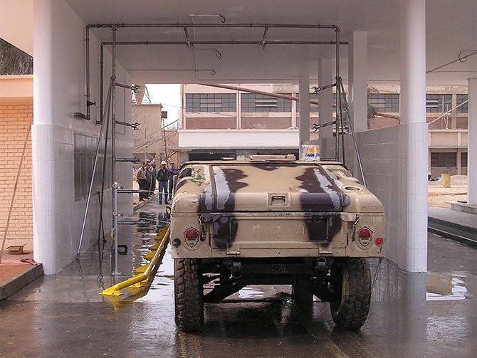 Military vehicle in fleet wash tunnel